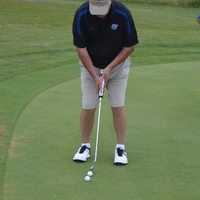 An alumnus golfing on The Meadows Golf Course.